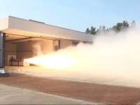 Burning a rocket motor at WTD 91 A large jet of flame coming from inside a hall