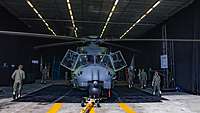 Helicopter in a dark hangar