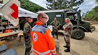 Ein Vertreter des Deutschen Roten Kreuzes im Gespräch mit Soldaten