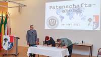 A course participant and a sponsor sign a paper stating that they are entering into a sponsorship