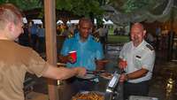 Two course participants help themselves to the barbecue buffet