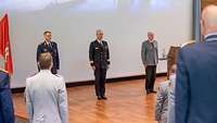 Major General Kohl, Flotilla Admiral Bock and Brigadier General Neumann standing to attention during the national anthem