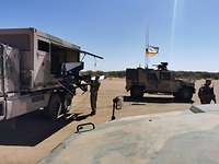 Jeder Handgriff sitzt Mehrere Soldaten holen aus einem Lkw mit seitlich geöffneter Klappe Teile der Drohne heraus