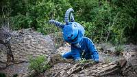 Eine lustige Puppe in Form eines Steinbocks in Felslandschaft.