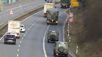 Auf einer Bundestraße fahren Militärfahrzeuge hintereinander.