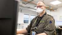 Ein deutscher Soldat sitz Bildschirmarbeitsplatz 