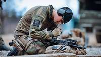 Ein norwegischer Soldat arbeitet mit einem Werkzeug an seiner Waffe