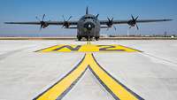 A C-130J stands on the airfield of Base Aérienne 105.