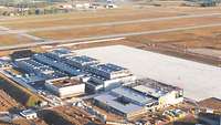 Aerial photograph of the squadron site with its hangar complex, buildings and parking areas.