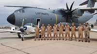 A400M-Crew und Ausbilder in Arizona stehen in Reihe vor der Bonnie, dahinter ein A400M.