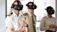 Three senior officers are wearing VR goggles assessing their added value for the exercise.