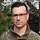 Oberstleutnant Christian Mönch Ein Soldat im Porträt. Im Hintergrund steht ein Wappen mit der Aufschrift „VersBtl 131“.