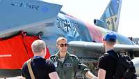 Crewmitglied des Eagle Star Eurofighters unterhält sich mit zwei Männern