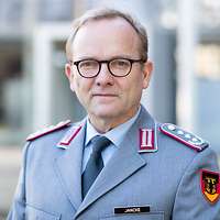 Colonel (GS) Jancke is looking into the camera