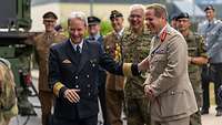 Vizeadmiral Daum ist im Gespräch mit Uk StratCom General Tom Copinger-Symes. Beide lachen.