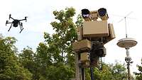 A drone in midair next to the ASUL defense system