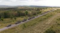 Auf einer Straße sind über 30 Fahrzeuge der Jägerkompanie zu einem Marschband aufgefahren