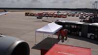 A taxiway with dozens of ambulances in the background