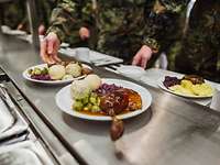 Christmas dinner is served to soldiers.