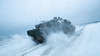 Ein Leopard 2 Kampfpanzer fährt durch den Schnee