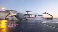 Enteisungsfahrzeuge besprühen ein Flugzeug.