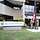 Service members hoist the American flag in front of the building of the Office of Defense Administration, U.S.A. and Canada