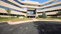 Exterior view of a building with a parking lot in front