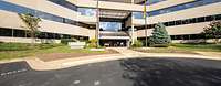 The headquarters of the BWVSt, USA and Canada Exterior view of a building with a parking lot in front