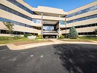 The headquarters of the BWVSt, USA and Canada Exterior view of a building with a parking lot in front