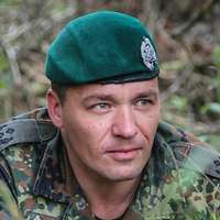 Ein Soldat liegt im Rasen.