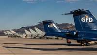 GFD Learjets, Tornados and Eurofighters parked at an airfield in the Nevada desert.