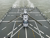 Enhanced markings on the landing pad A helicopter is standing on the landing pad of a large vessel. There are landing markings on the landing pad.
