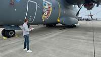 Ein ziviler Mitarbeiter vor einem A400M Flugzeug auf dem Vorfeld