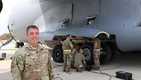 An American soldier standing at an aircraft tyre change.