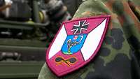 Bordeauxfarbiges Abzeichen auf der Schulter eines Soldaten.