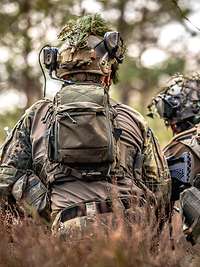 Two soldiers squatting in the forest