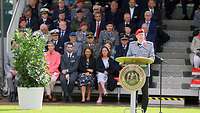  Generalmajor Oliver Kohl steht am Rednerpult. Hinter ihm sitzen Menschen auf der Tribüne