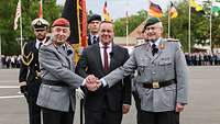 Zwei Generäle und der Verteidigungsminister stehen zusammen