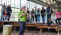 Ein Mann in einem grünen T-Shirt spricht auf der Spurenfläche zu Besuchern des Parks.