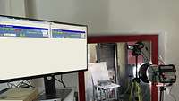 A computer screen and various technical devices in a laboratory.