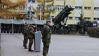 Ansprache von Generalleutnant Schütt Ein Soldat steht an einem Rednerpult, im Hintergrund sind weitere Soldaten angetrteten.