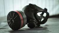 An ABC protective mask lies on a table