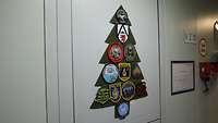 Weihnachtsbaum aus grünem Plüsch. Die Weihnachstbaumkugeln werden durch verschiedene Patches dargestellt. 