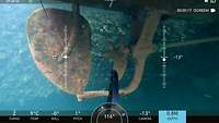 Underwater shot of the ship propeller and a blue grabber.