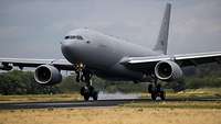An aircraft lands on a runway.