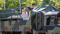 Ein Soldat und eine Frau auf der Ladefläche eines LKW