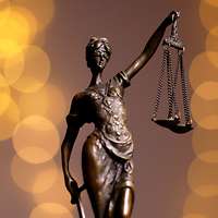 Eine Figur von Justitia, die eine Waage in der Hand hält