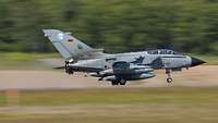 A tornado jet fighter lands.