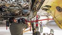 A soldier works on a Tornado combat aircraft.