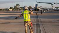 An Aircraft is directed to its parking space at the airfield.